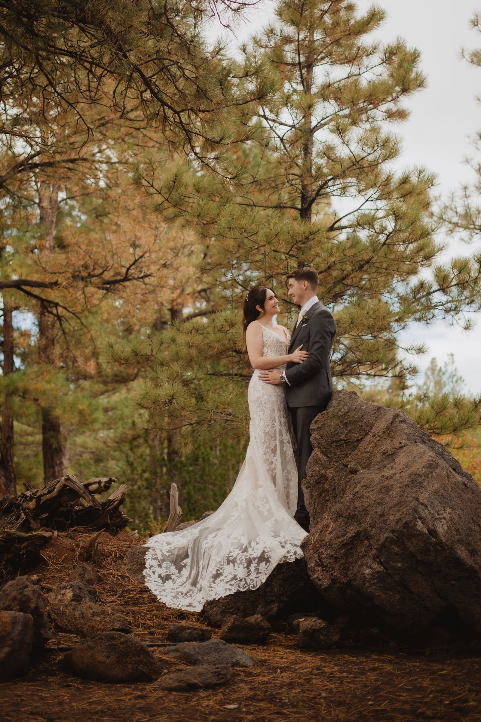 Brittney and Trevor standing among the Flagstaff pines