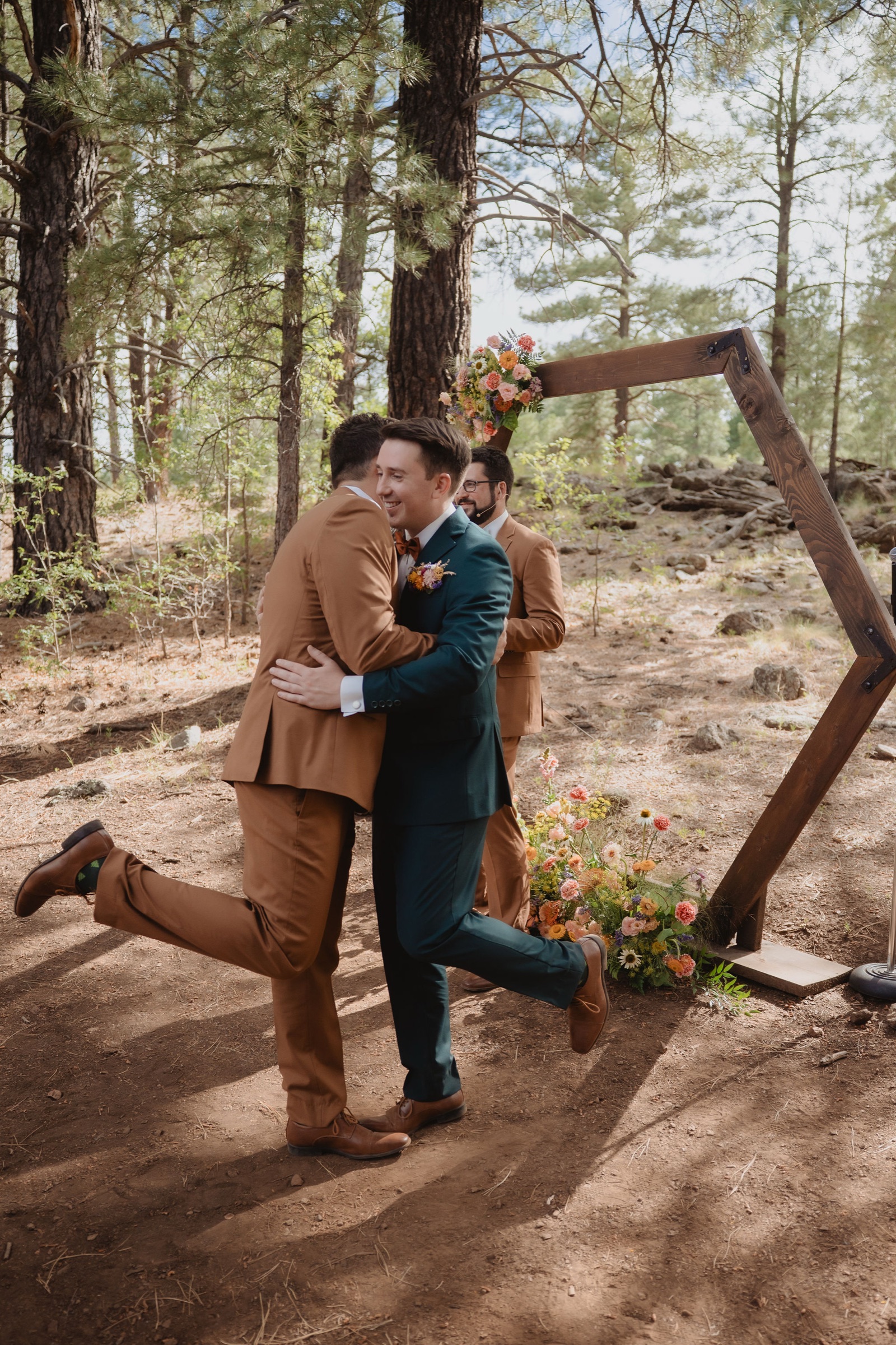 Kellie and Jake inside the octagon ceremony frame in the woods