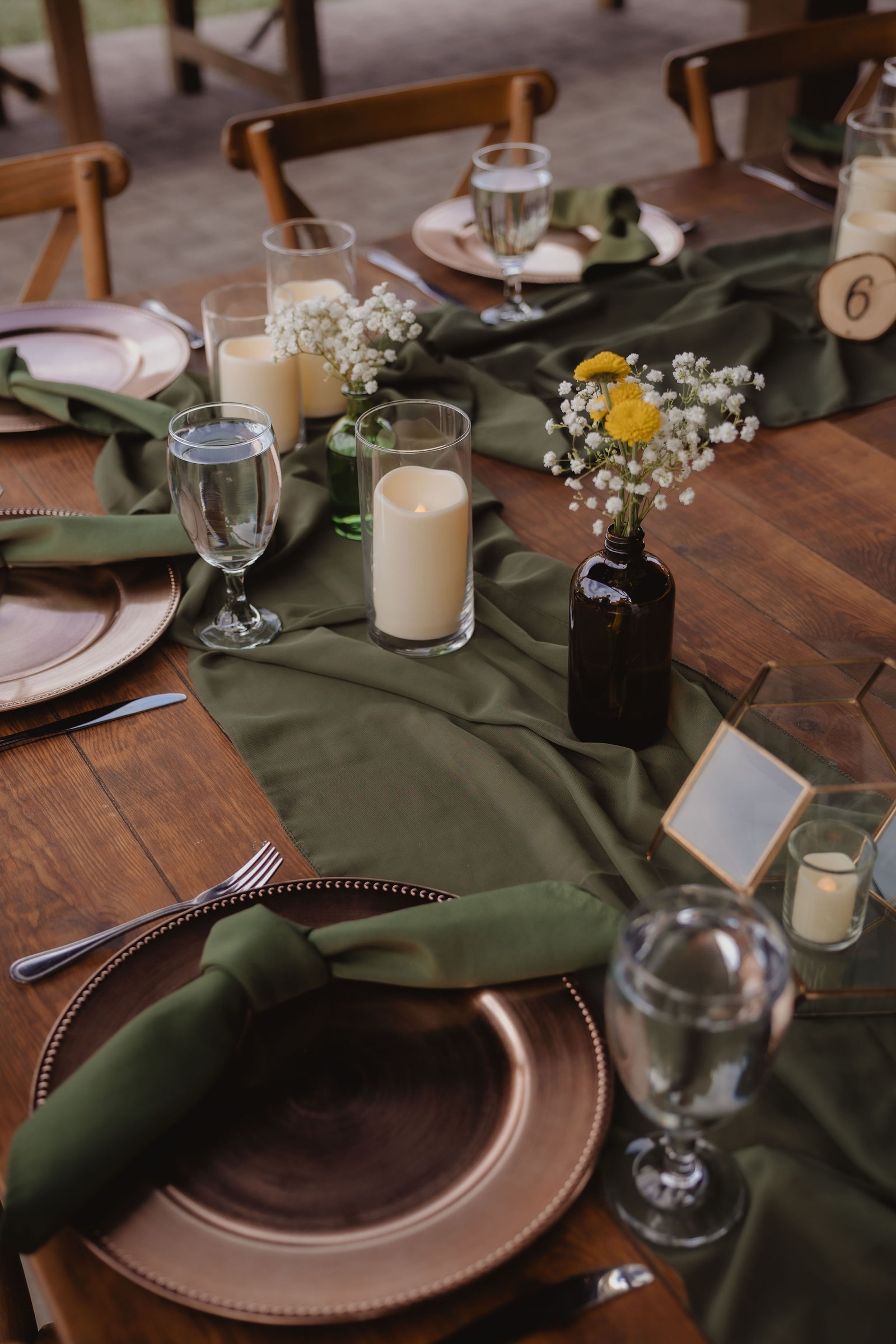 Reception table details with green and warm floral colors
