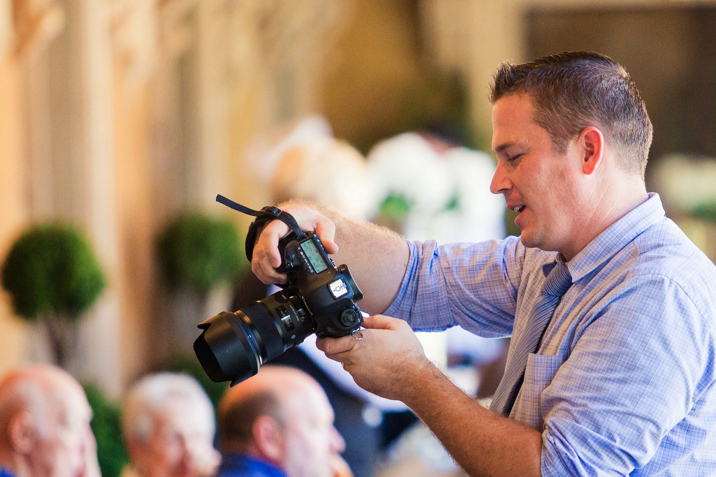 Trevor Dayley photographing a wedding reception