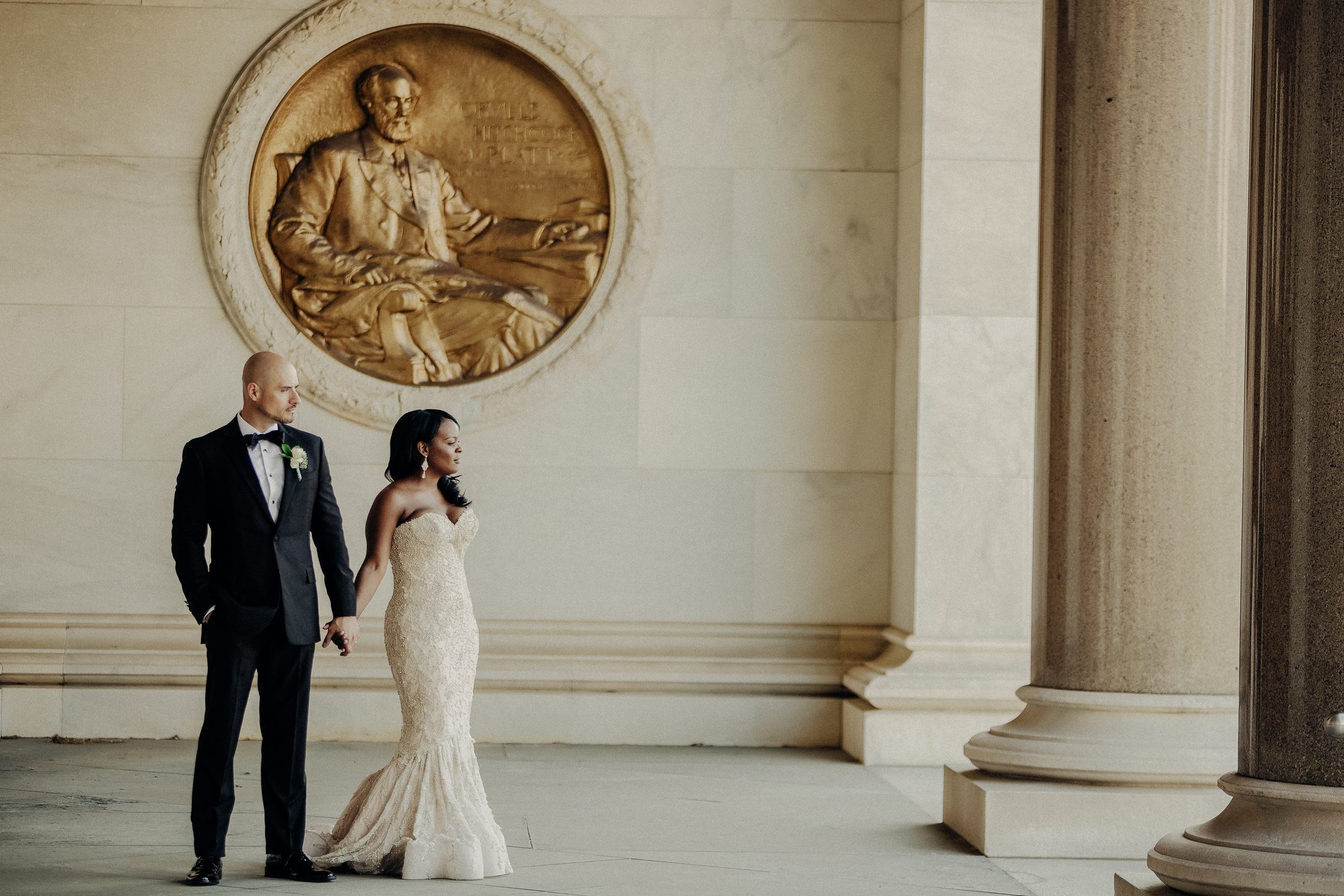 Editorial wedding portrait framed by architecture