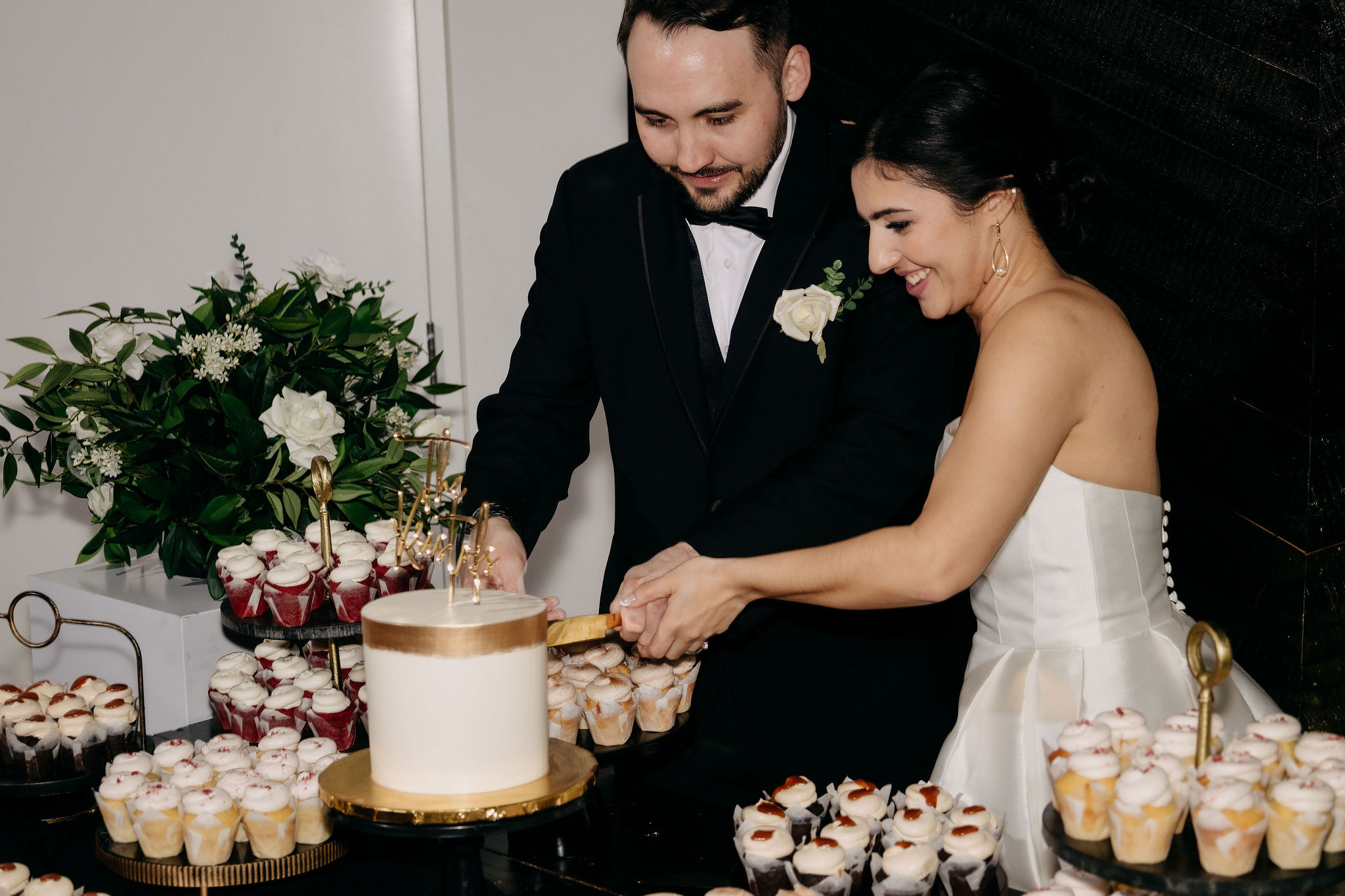 Alexa and Jerome cutting their wedding cake