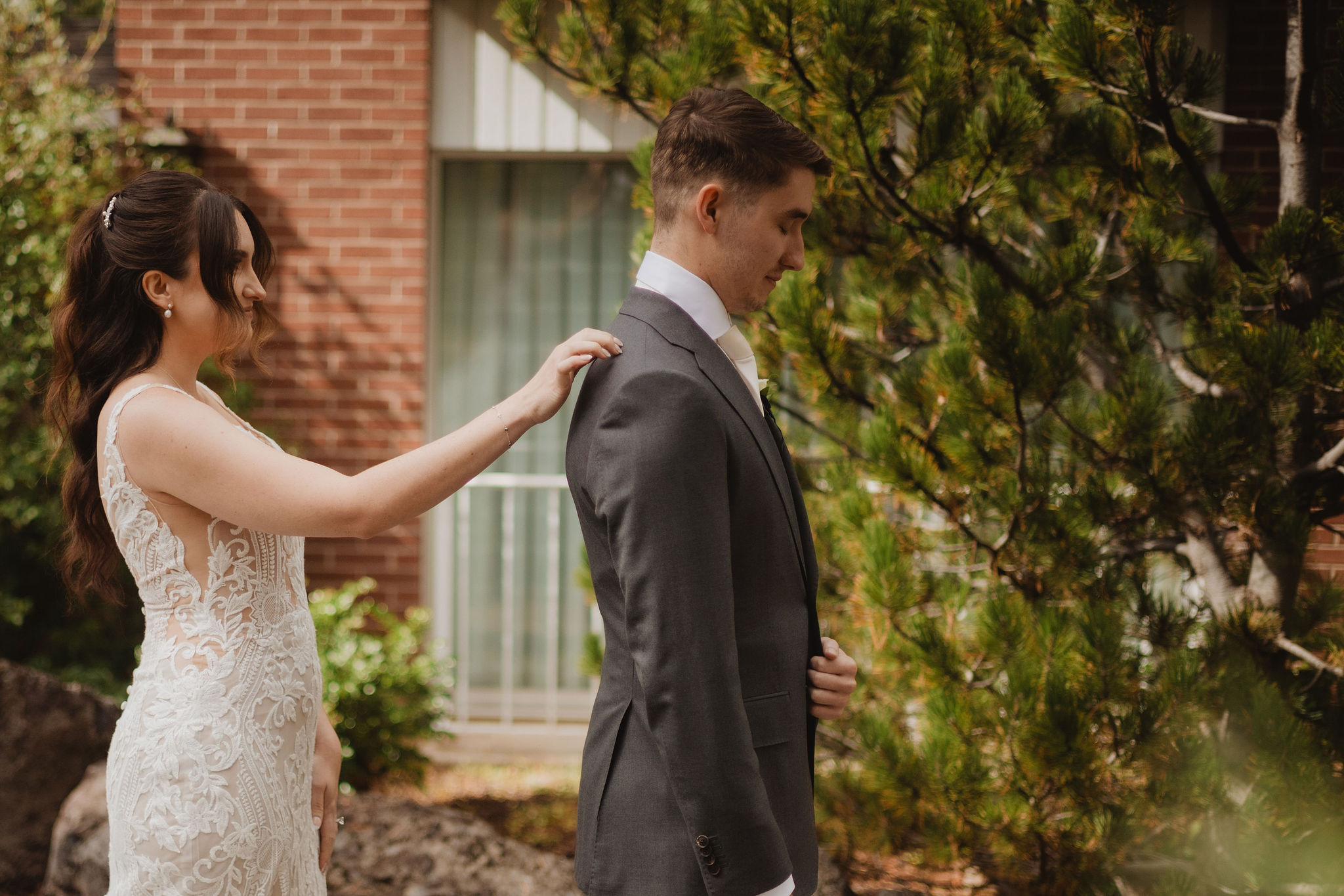 Brittney fixing Trevor’s suit before portraits