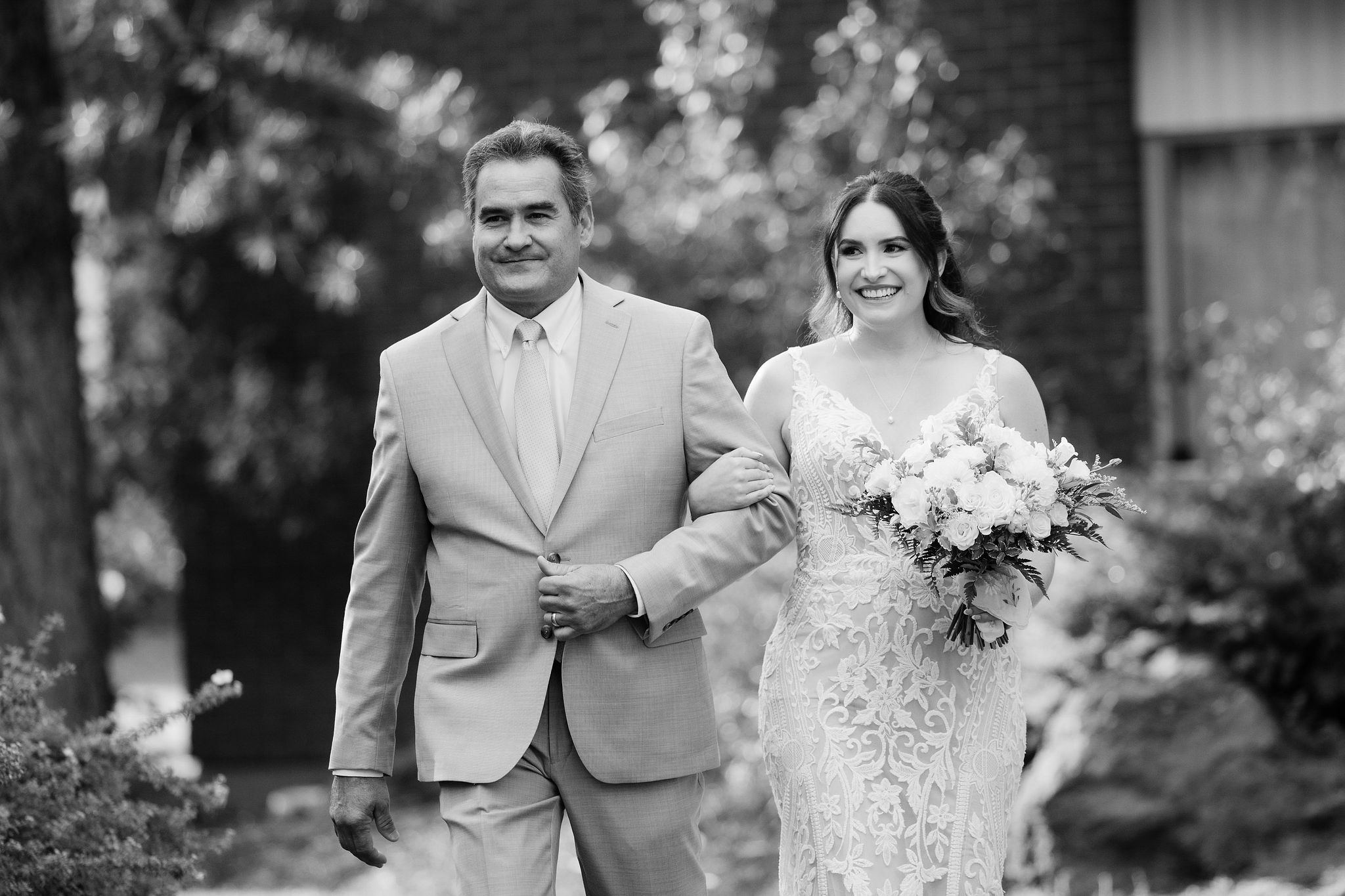 Brittney walking with her father before the ceremony