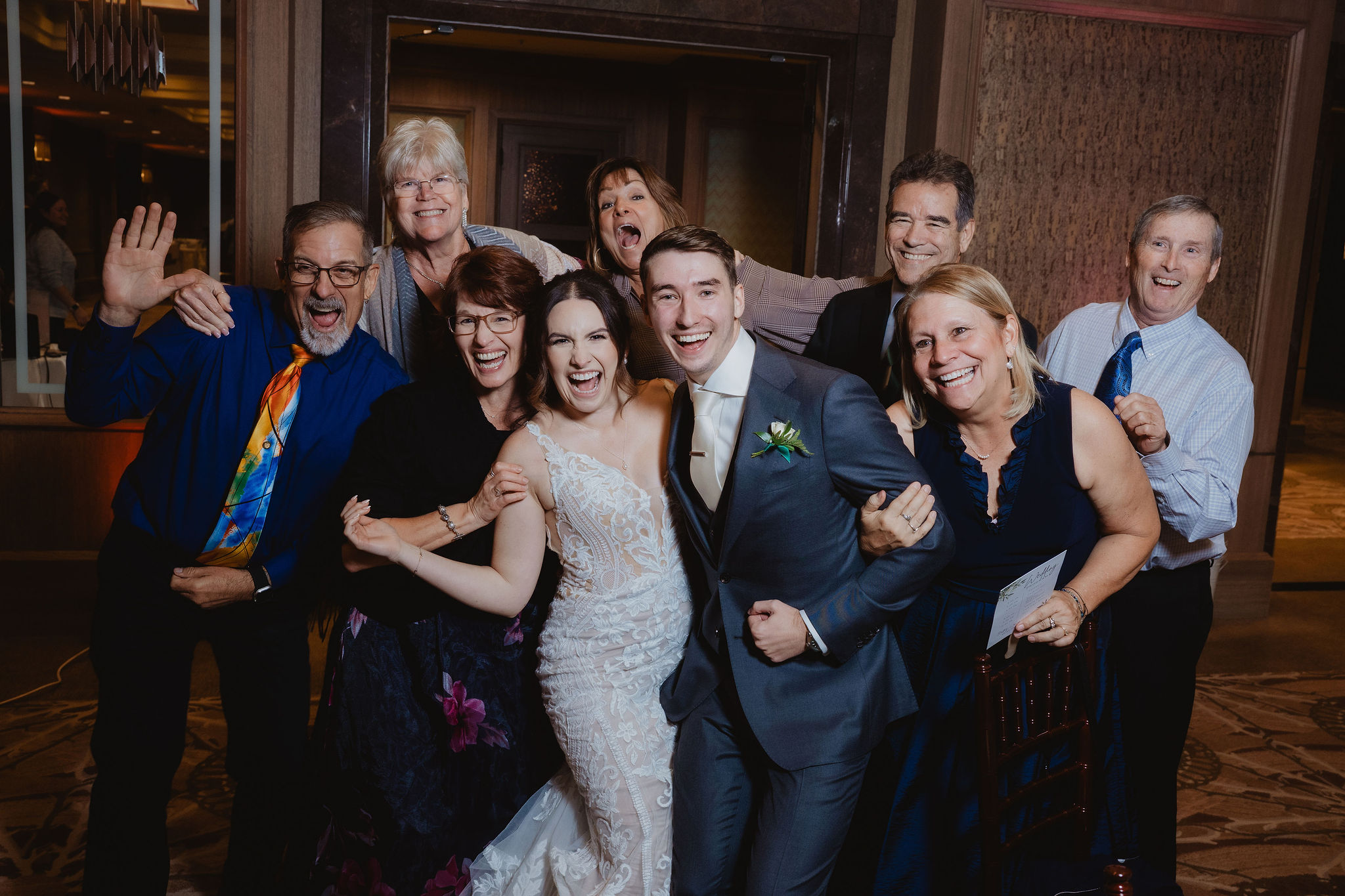 Wedding guests posing with Brittney and Trevor during the reception