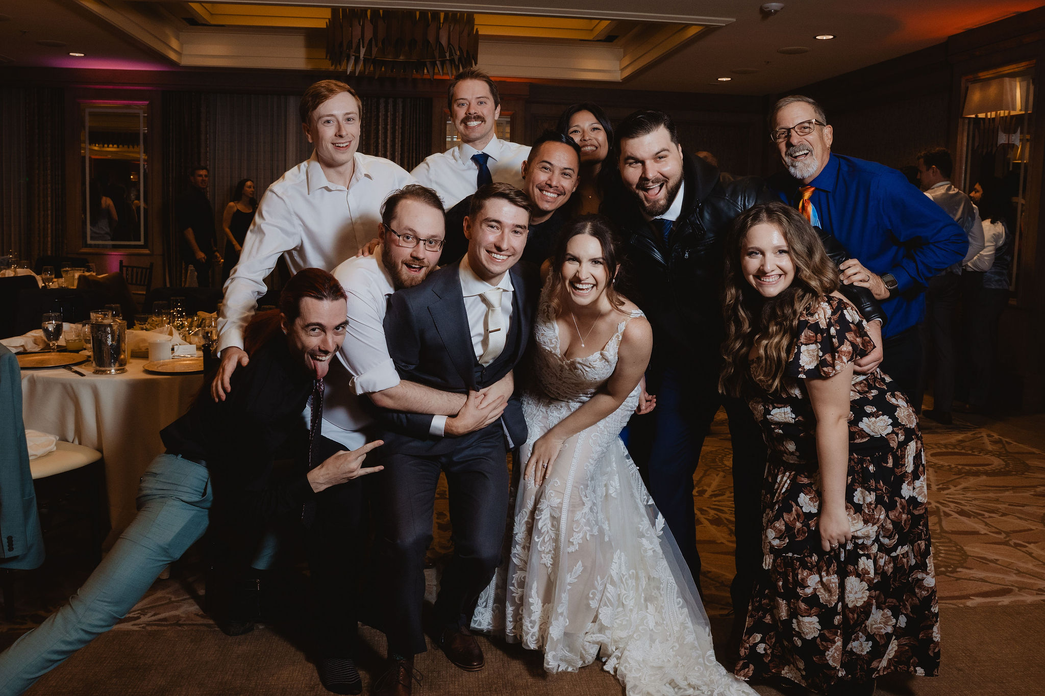 Wedding guests posing around Brittney and Trevor