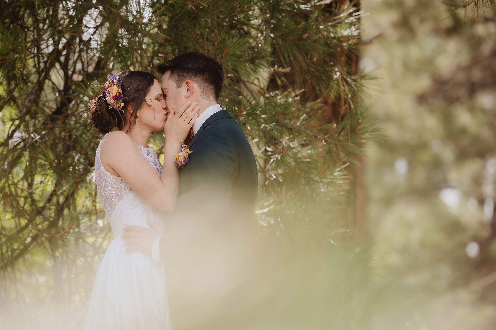 Kellie and Jake kissing in the trees