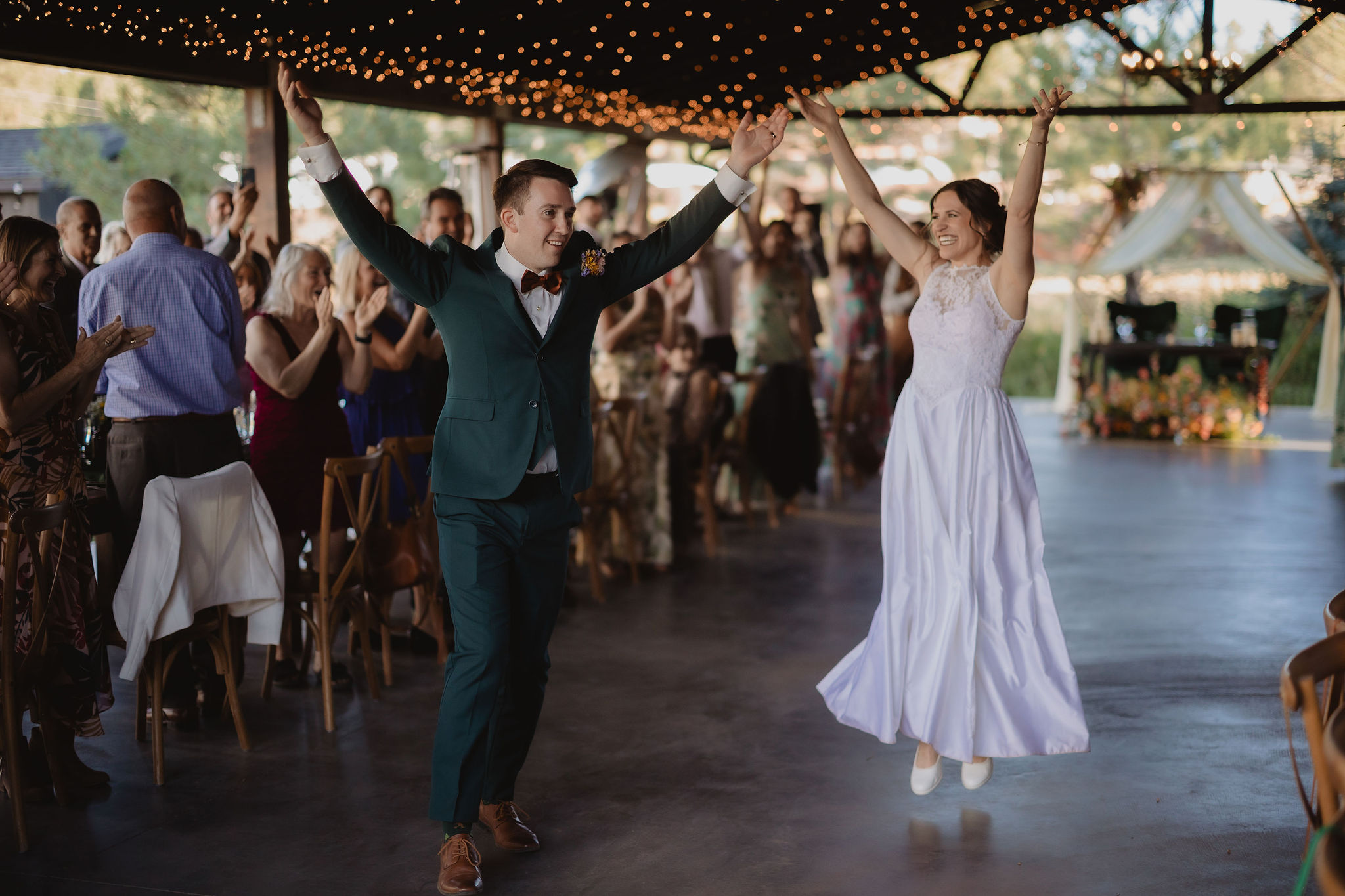 Kellie and Jake entering the reception with friends and family cheering