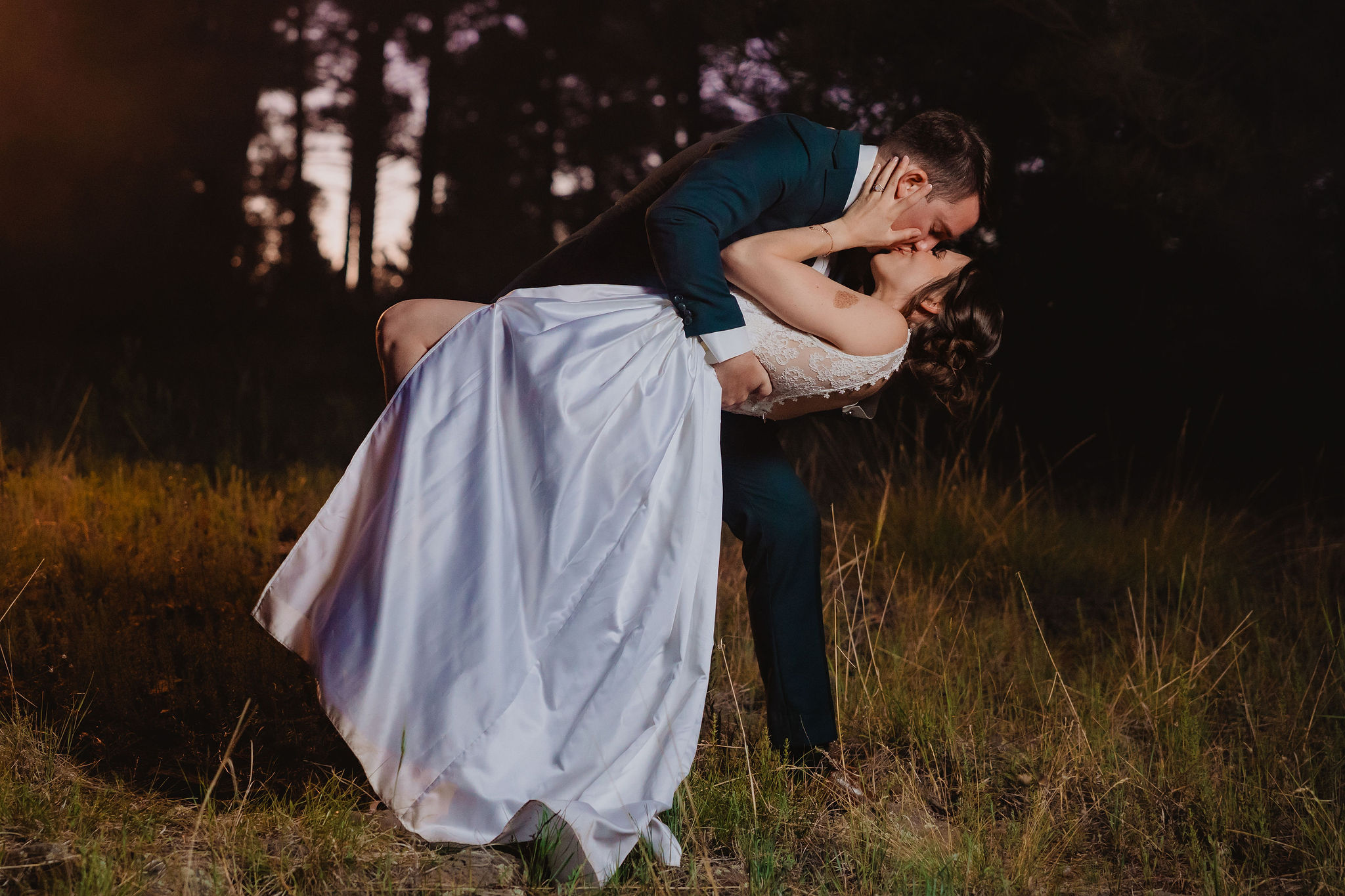 Kellie and Jake kissing in the field at night