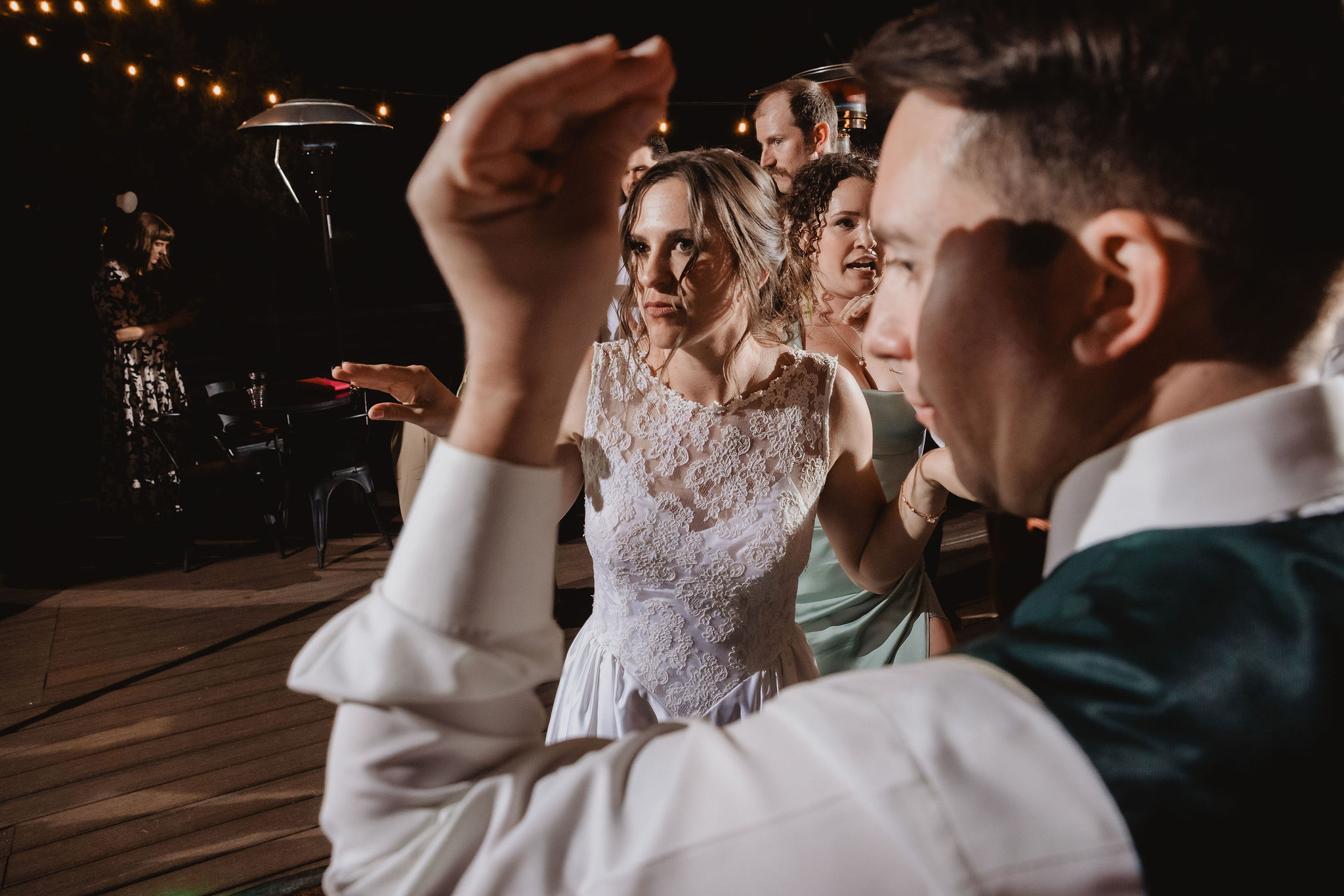 Kellie and Jake dancing with guests at night