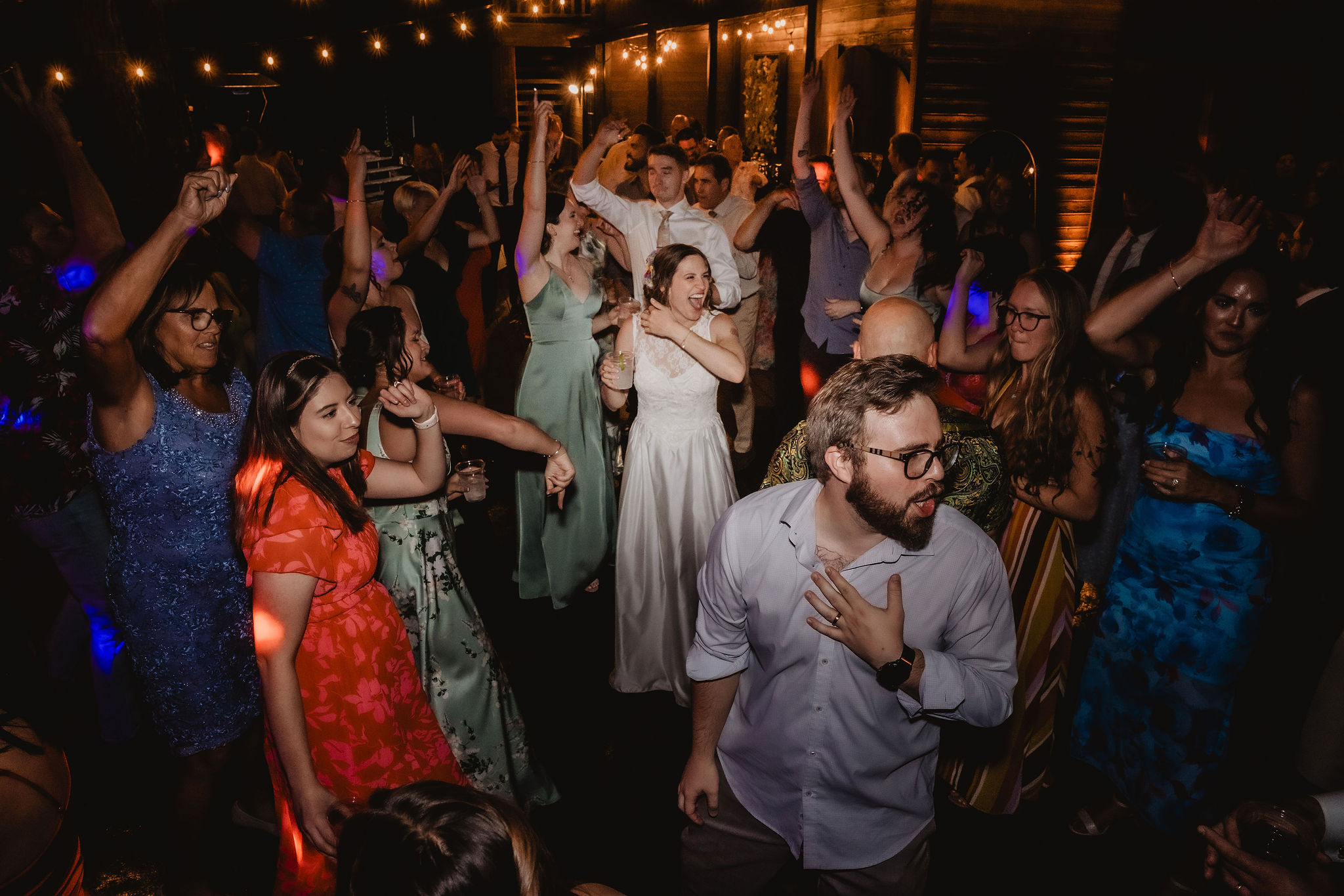 Kellie and Jake on the dance floor with friends and family