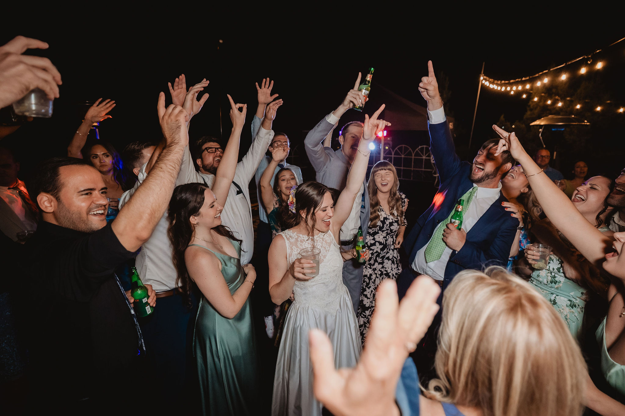 Friends cheering on the dance floor at Kellie and Jake’s wedding